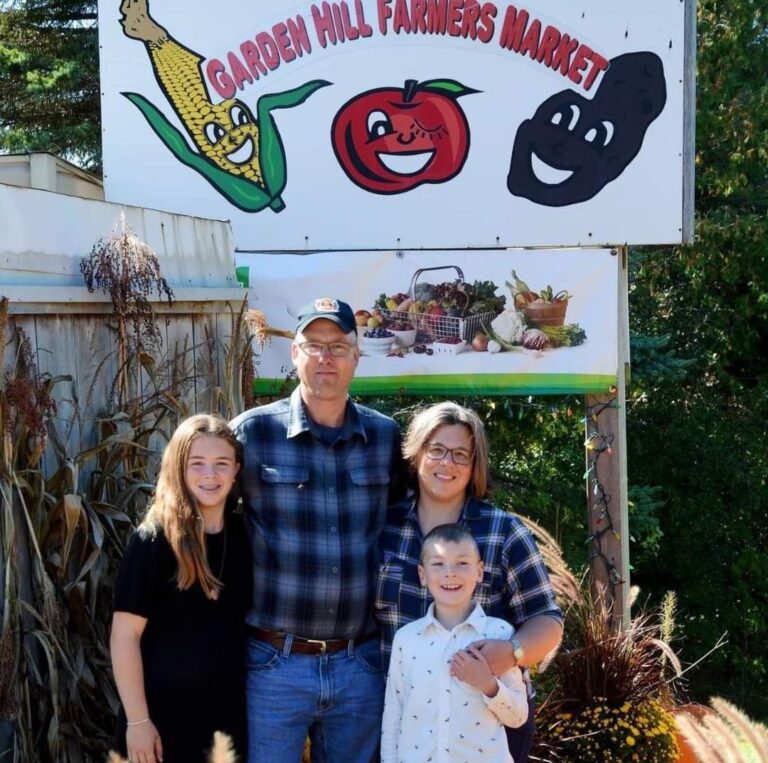 Ferguson Family in front of Garden Hill Farmers Market Sign